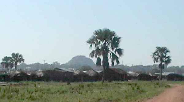 Nakatonya IDP camp near Soroti, with rock hill in background.